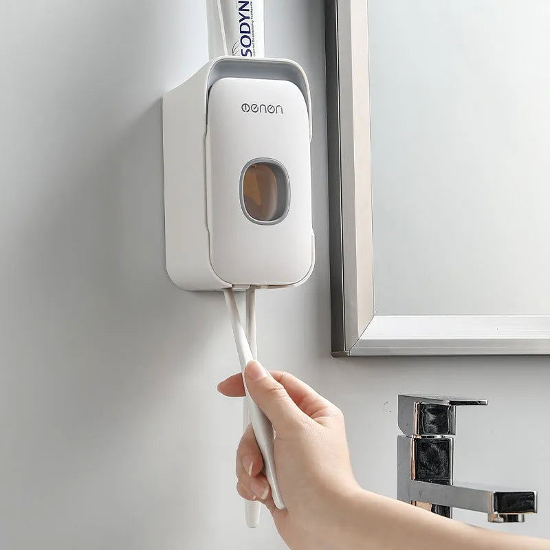 Automatic toothpaste dispenser in blue colour mounted on bathroom wall