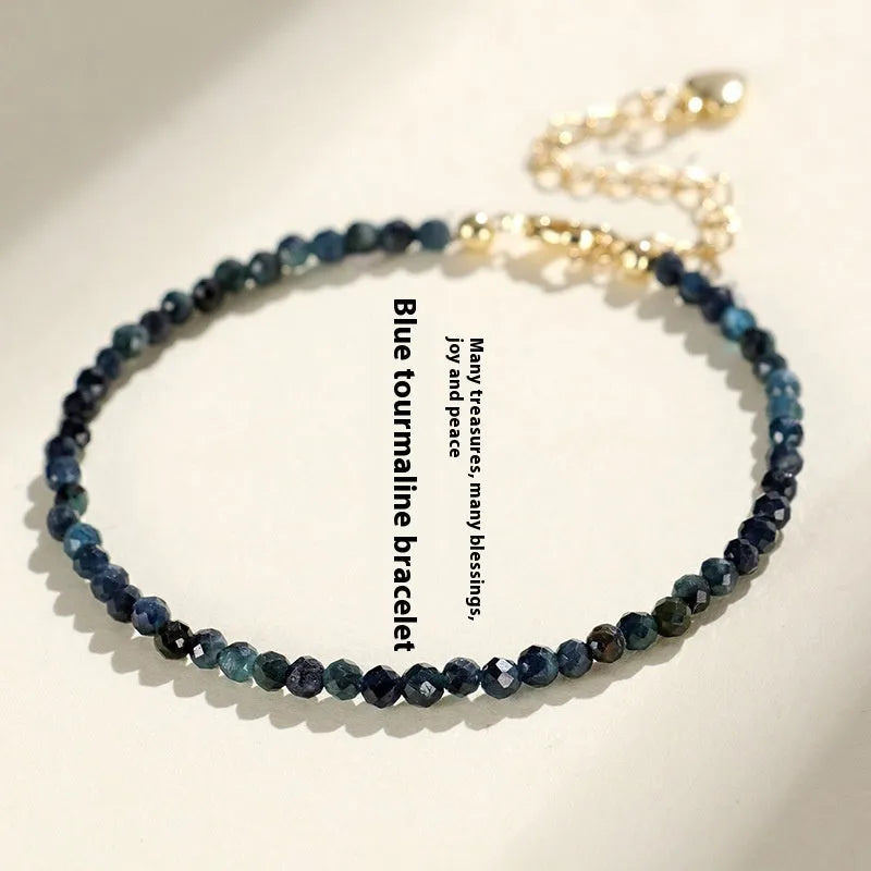 Blue tourmaline 3mm bead bracelet with spacer design on wrist