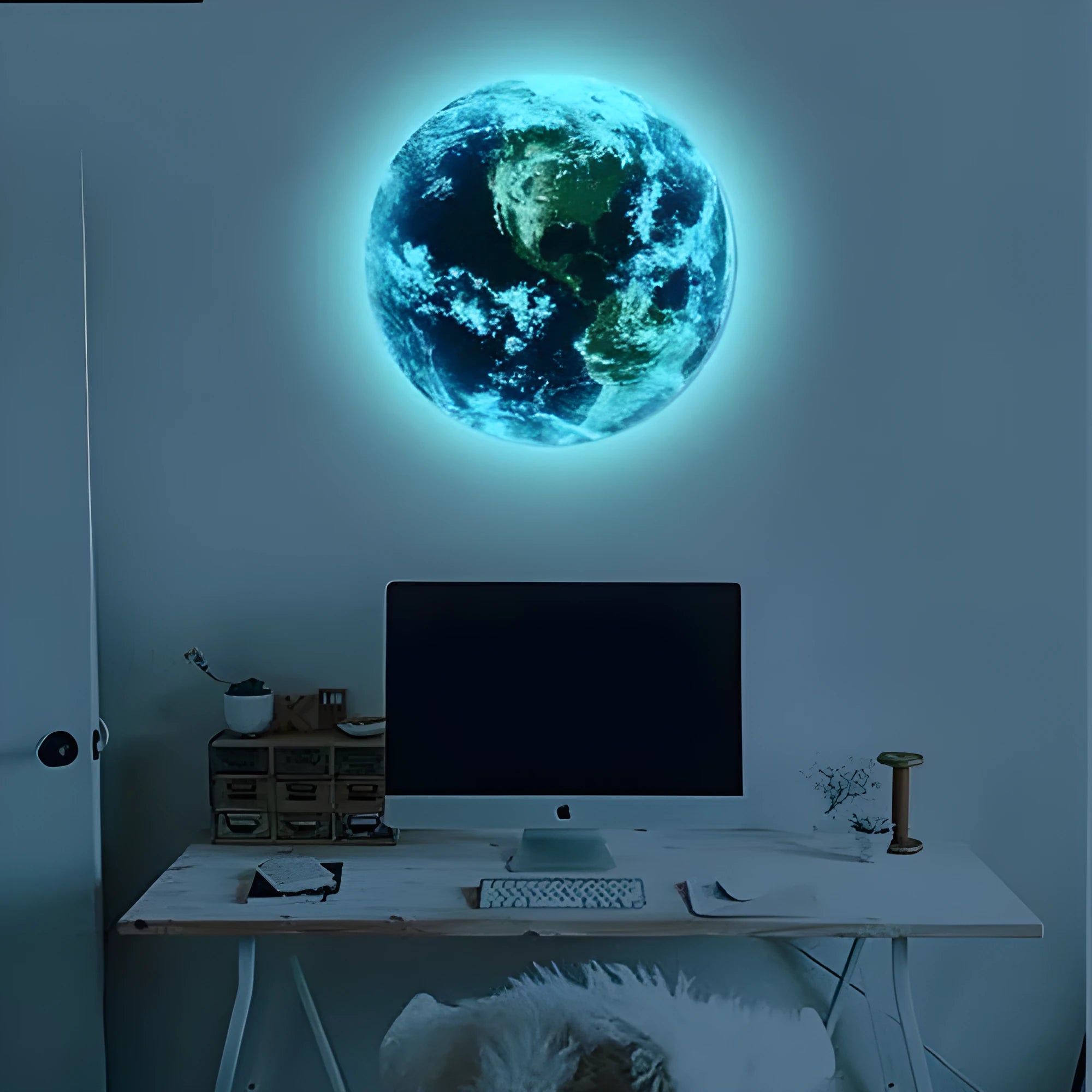 Glow in the dark 3D Earth planet wall sticker in multiple sizes on a dark wall.