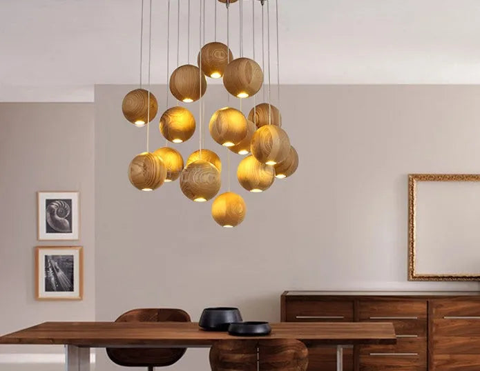 Nordic style solid wood ball chandelier pendant light hanging from ceiling on adjustable cord.