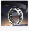 Silver and gold smart ring with diamond inlay on a finger, showing its health monitoring design.
