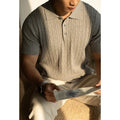A man's khaki short-sleeve business commute top laid flat, showing its collar and sleeve detail.