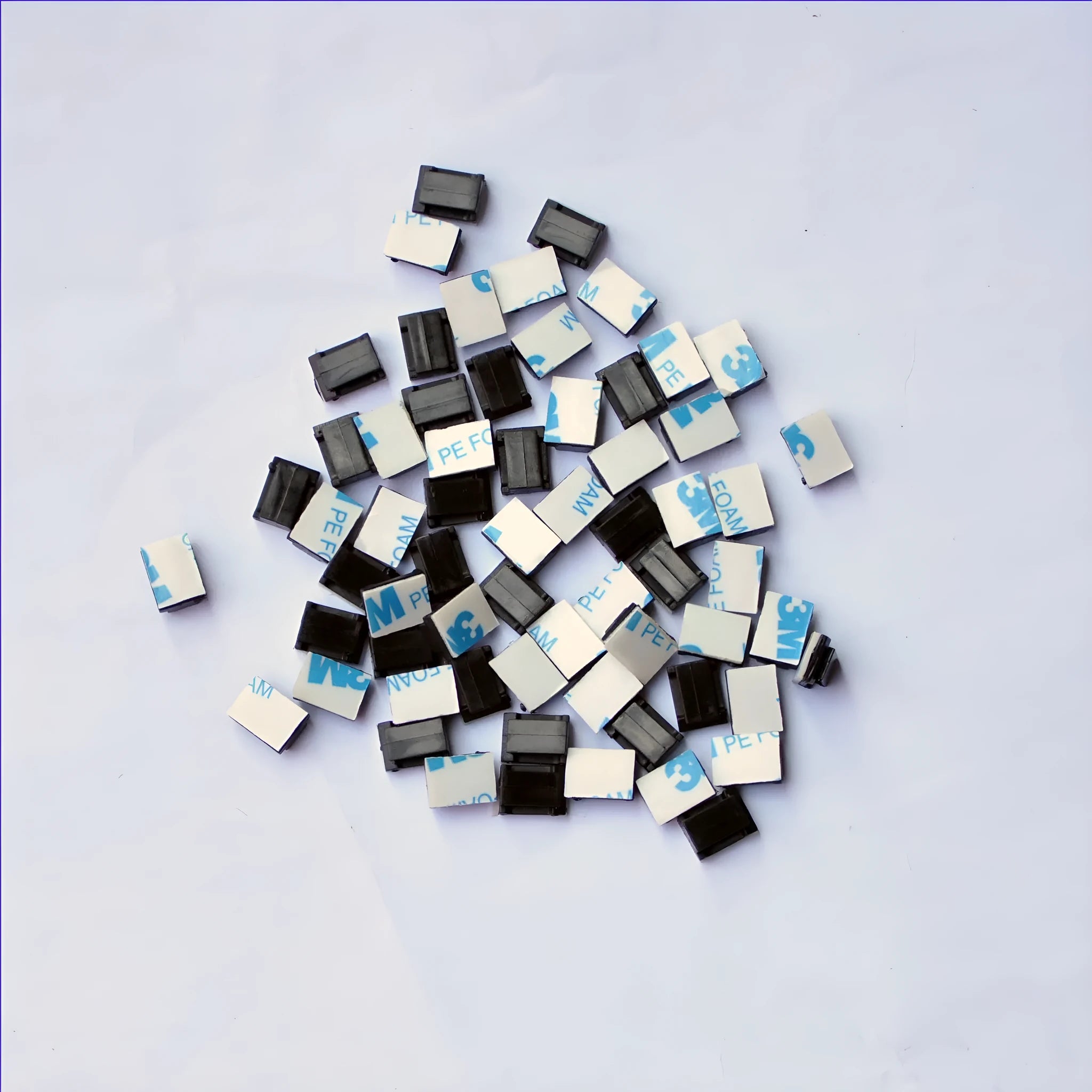 Black PA66 plastic wiring management clips for automotive and electronic cable organisation.