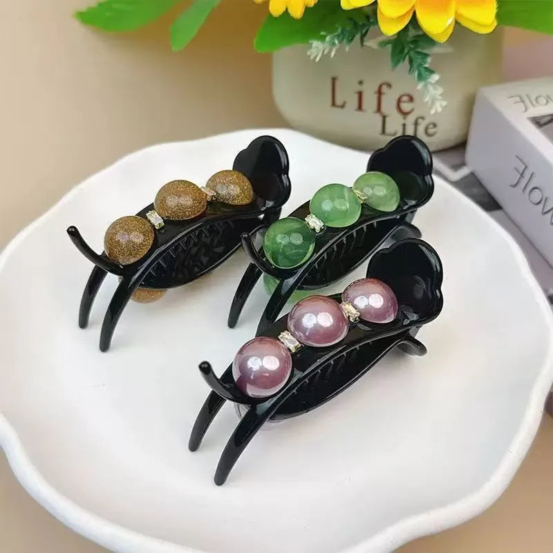 Acrylic pea barrette hair clip for women in green, shown against a dark background