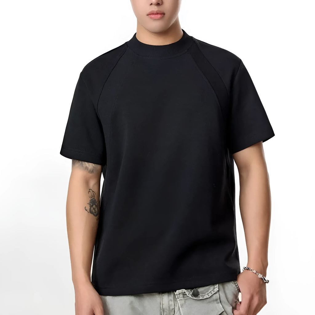 Man wearing a loose fit grey short sleeve top with visible air layer stitching texture.