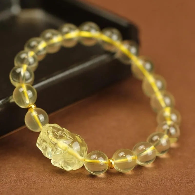 Yellow leather Citrine Pi Xiu bracelet with a clear artificial crystal charm in Chinese simple style.