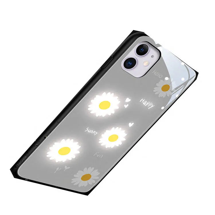 White iPhone case with painted daisy design and illuminated voice-activated colour light.