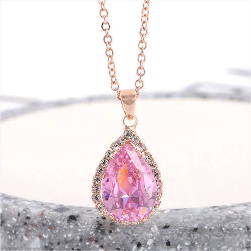 Pink drop shape women's necklace with geometric pendant design and rhinestone details