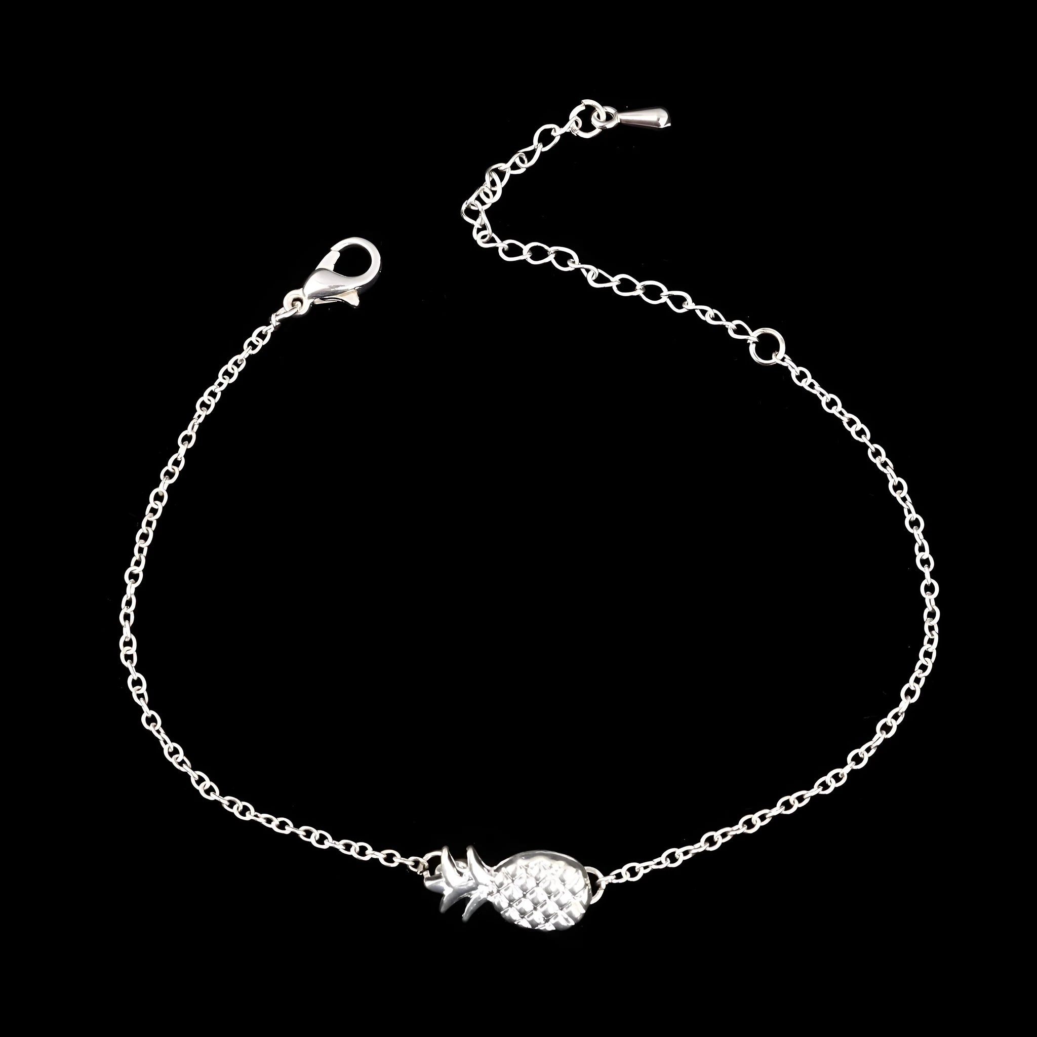 Close-up of a women's alloy bracelet with a small pineapple charm in gold or silver.