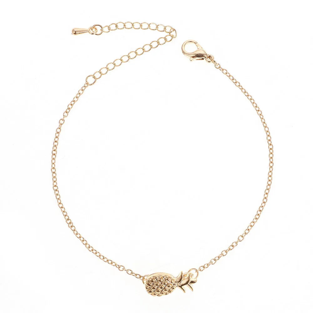 Close-up of a women's alloy bracelet with a small pineapple charm in gold or silver.