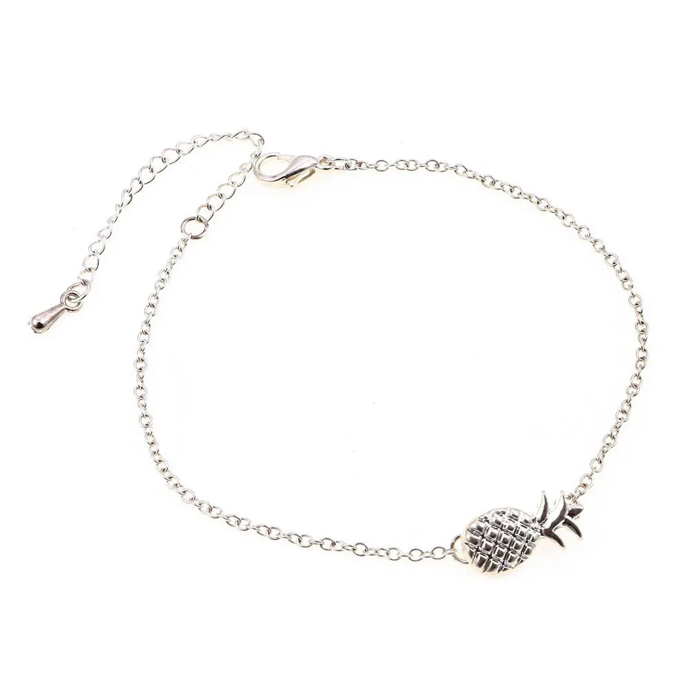 Close-up of a women's alloy bracelet with a small pineapple charm in gold or silver.
