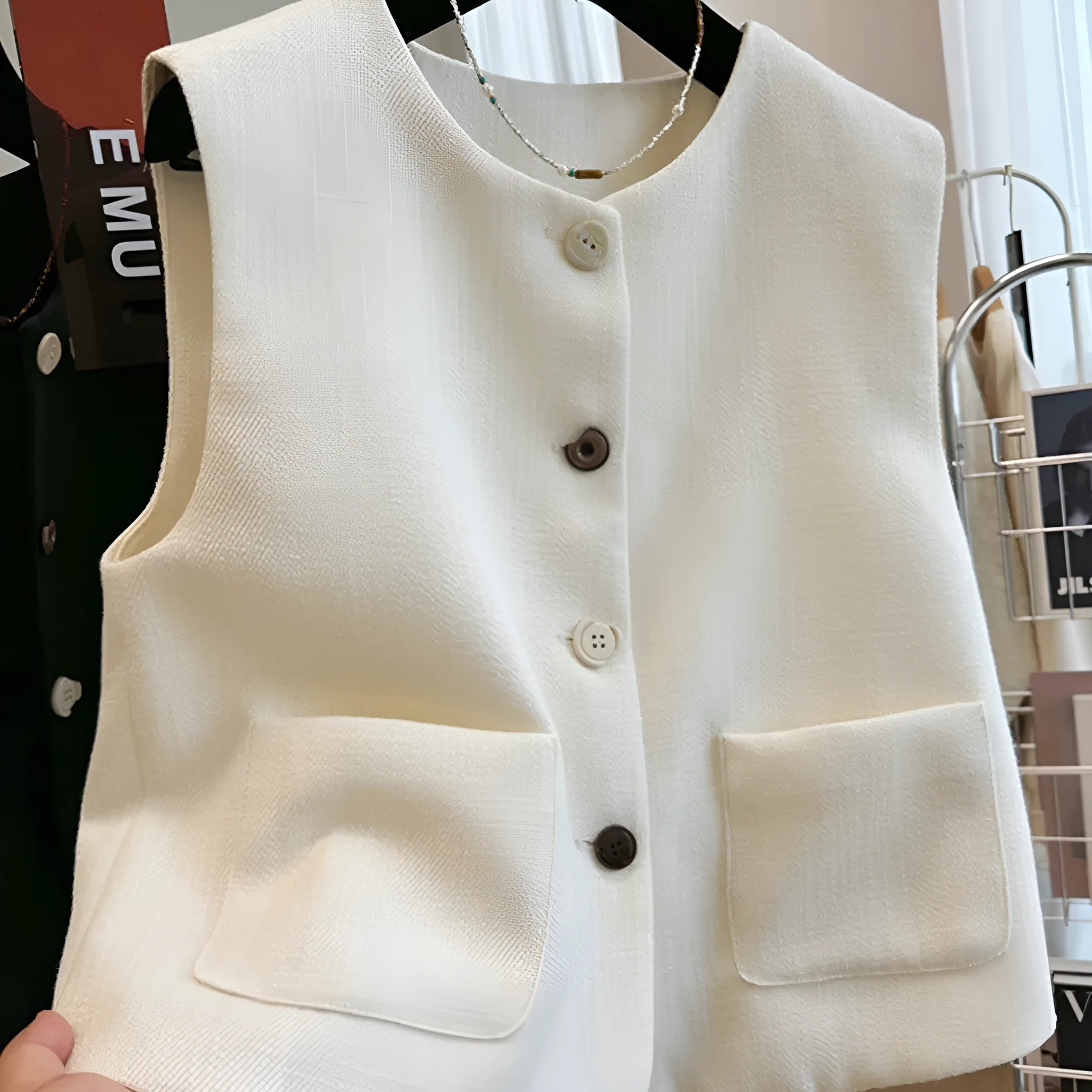 Women's French-style sleeveless bandage vest in beige, shown on a model, with a round neck and fitted silhouette.