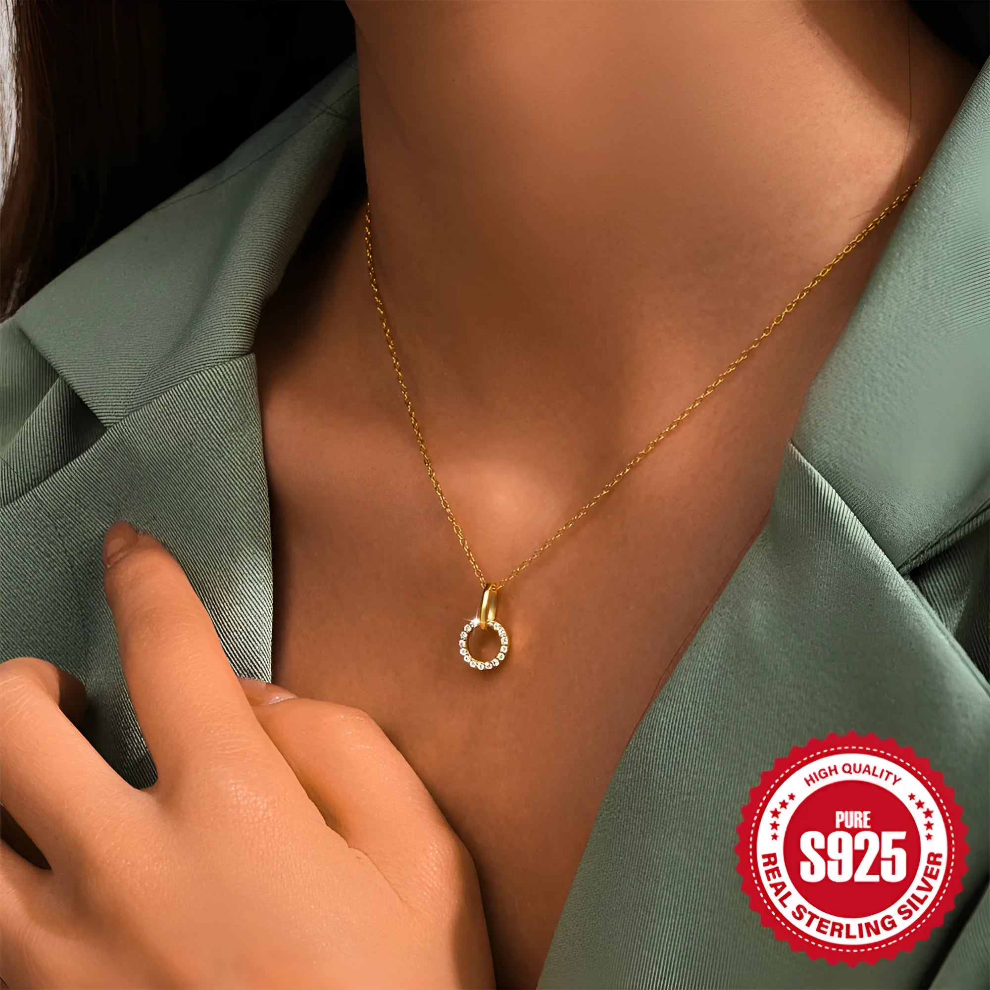 Gold-coloured sterling silver adjustable clavicle chain with interlocking geometric zircon pendant.