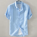Men's solid colour short sleeve linen blend shirt in loose fit, shown in apricot colour.