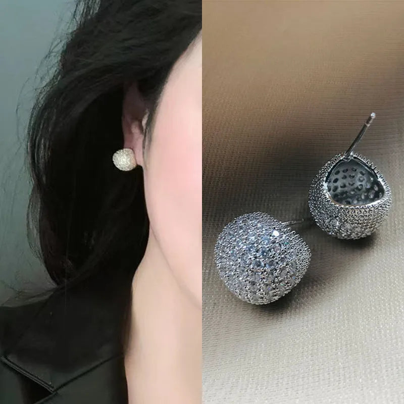 Gold and white geometric drop earrings with flashing lights and spherical elements