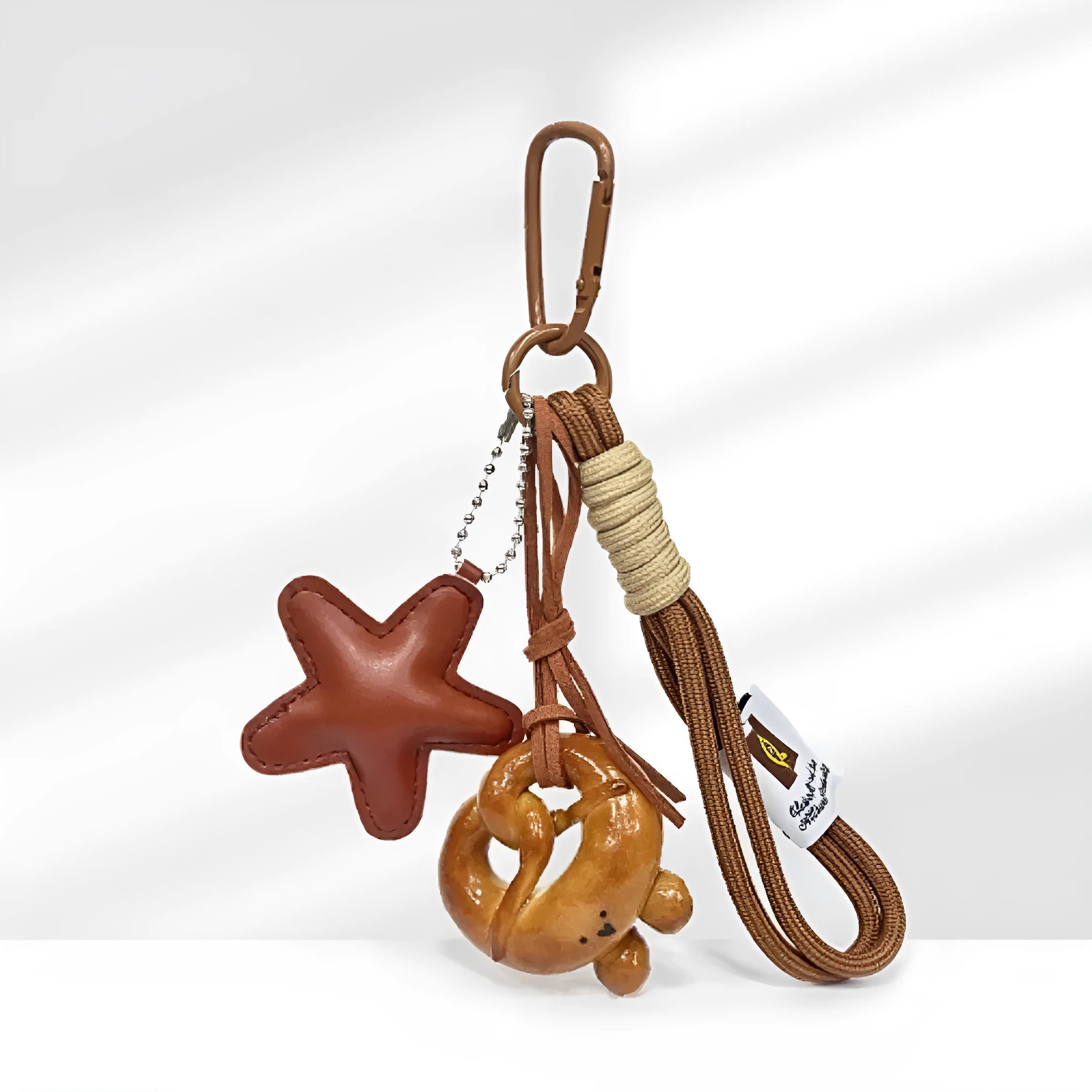 Handmade soda bread style resin handbag pendant with brown strap and food designs.