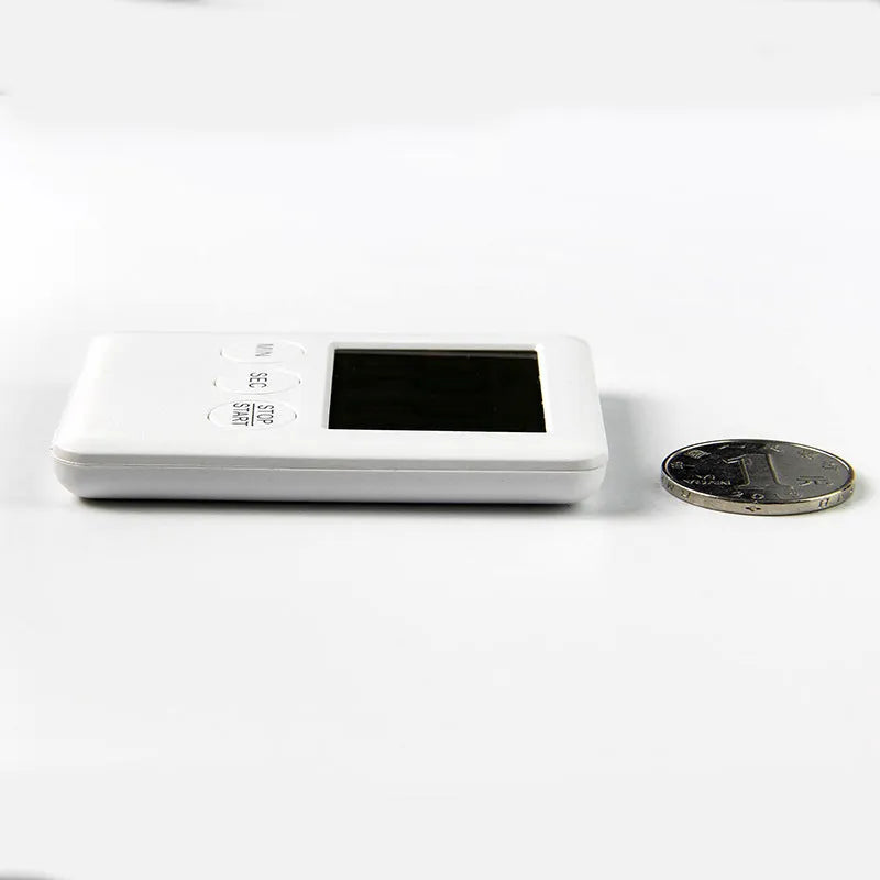 Black and white digital kitchen timer with magnetic back showing countdown display on 85mm circular face