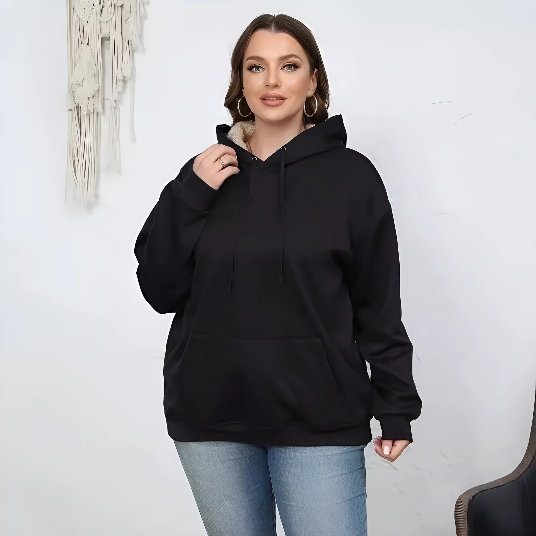Women's loose fit hooded sweater in thick grey polyester fleece with a 3D pattern and front pockets.