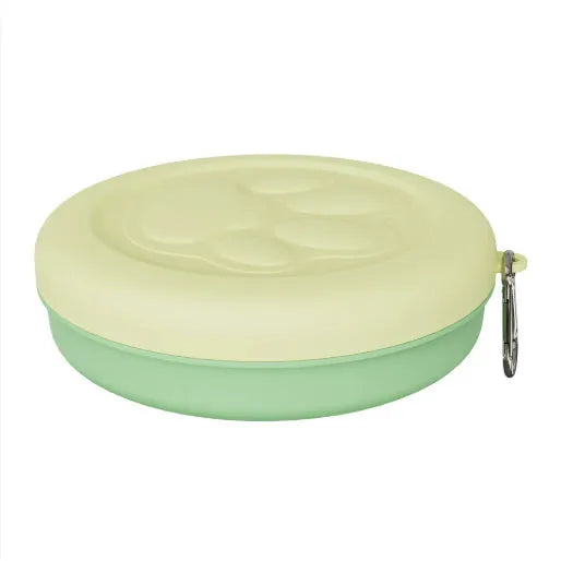 Portable dog food bowl with snack compartment in light green colour