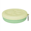 Portable dog food bowl with snack compartment in light green colour
