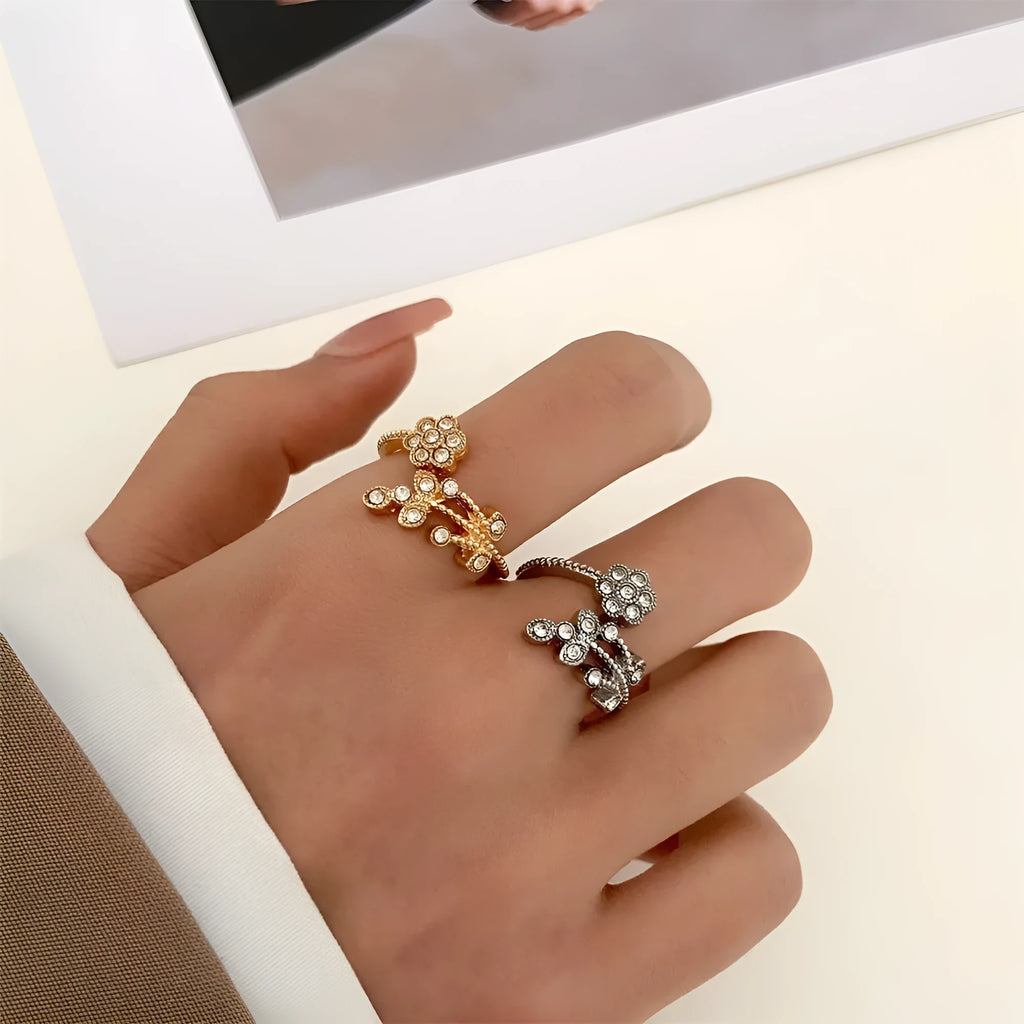 Women's open back copper ring with floral leaf design in a white diamond finish.