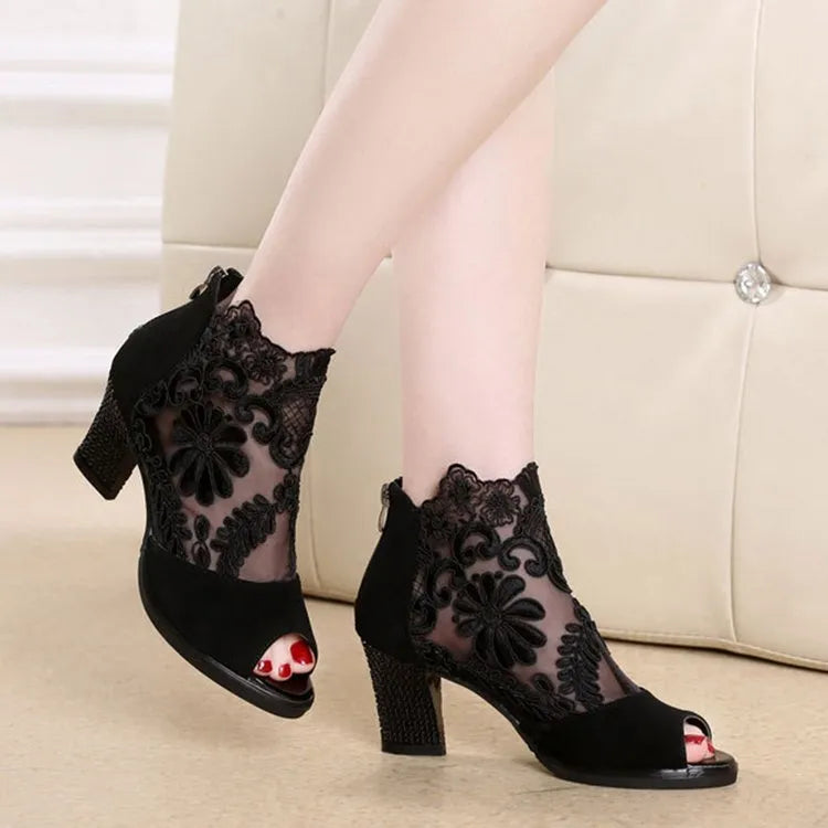 Women's black lace gladiator sandals with square heels and zip closure showing flower detailing