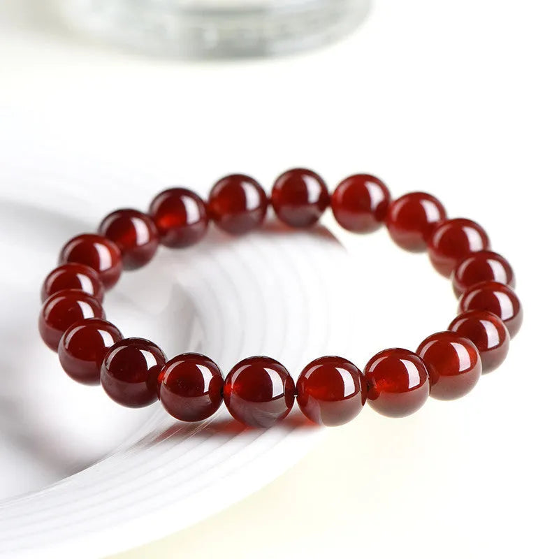 Natural orange red garnet ball bracelet with spherical crystal beads and traditional Ruyi decorative element