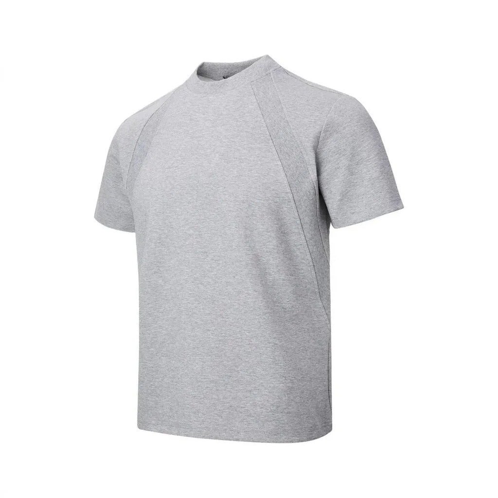 Man wearing a loose fit grey short sleeve top with visible air layer stitching texture.