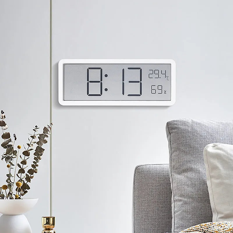 Simple large screen temperature and humidity clock with plastic shell in white Nordic style on a desk