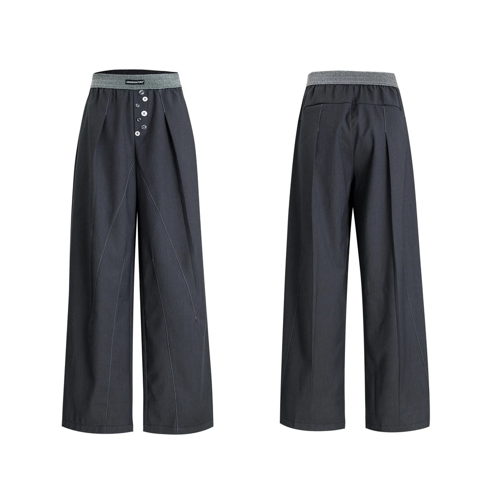 Drooping straight suit pants in black and grey colours showing high waist and button open line design detail.