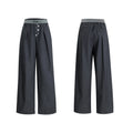 Drooping straight suit pants in black and grey colours showing high waist and button open line design detail.
