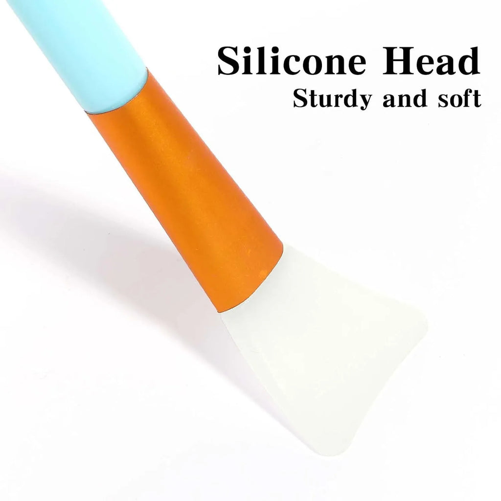 Reusable silicone face and body mask applicator spatula tool in one of six colours: black, blue, pink, rose red, white, or yellow.