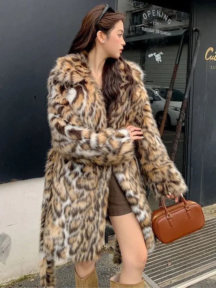A model wearing a black faux fur mid-length coat with a large fur collar and front pockets.