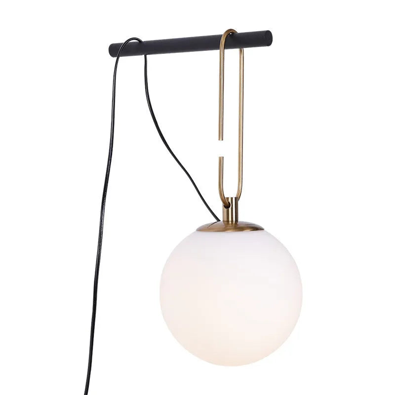 Nordic modern glass wall lamp mounted on a wall, showcasing its simple design and translucent glass shade.