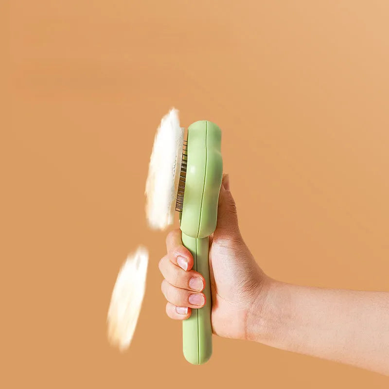Green self-cleaning stainless steel cat comb with needle teeth on a 20cm handle.