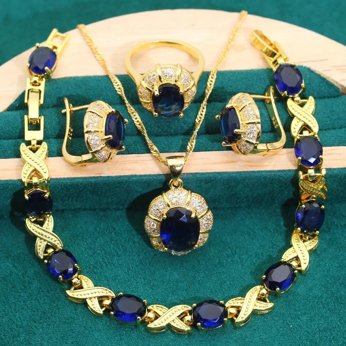 18k gold plated cubic zirconia jewellery set showing necklace, earrings, ring and bracelet in four colour options