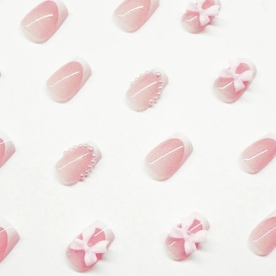 Set of short white French manicure nail art stickers showing bow, tulip, starry sky, and leopard print patterns.