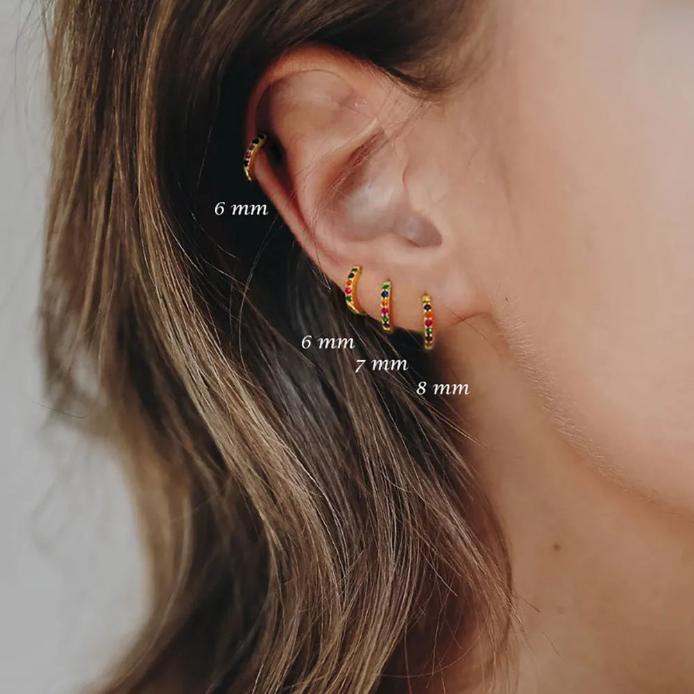 Women's circle zircon perforated stud earrings in gold, rose gold, and silver colour options showing geometric design