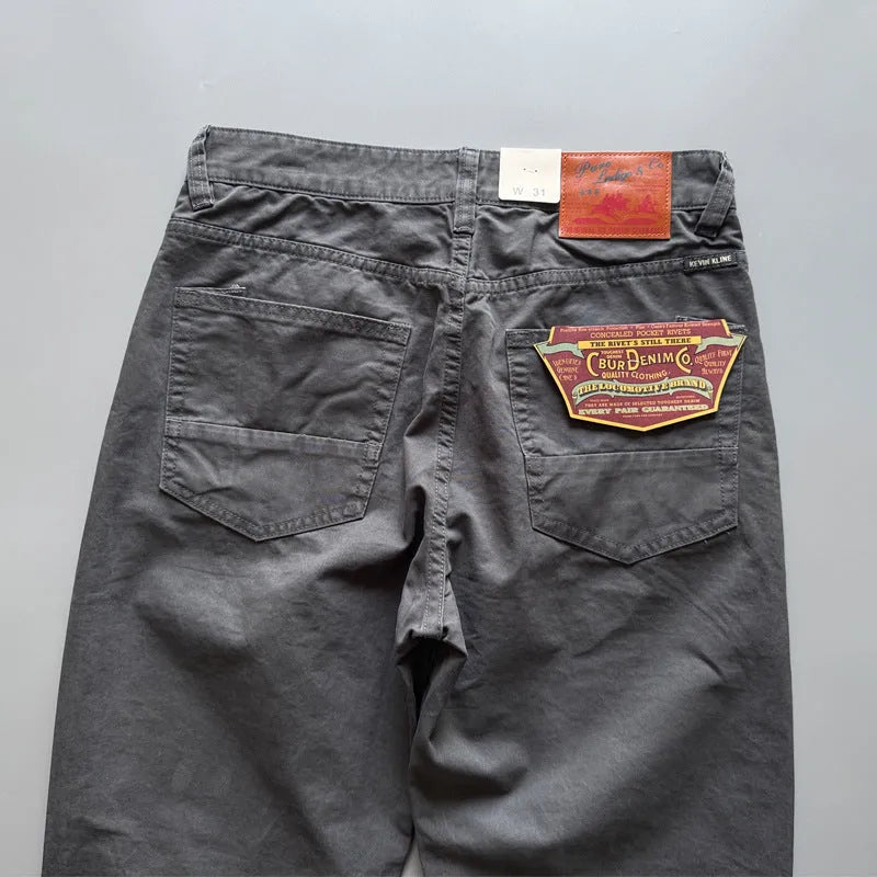 Men's straight leg casual cotton trousers in grey, army green, and khaki colours on a mid waist.