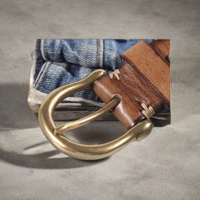 Men's black cattlehide leather belt with copper pin buckle on a pair of jeans