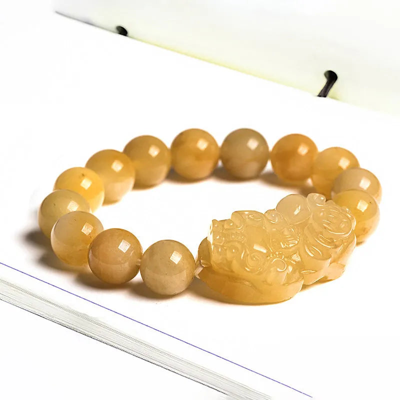 Carved golden thread jade money bracelet showing detail, available in large and small sizes with unisex design.