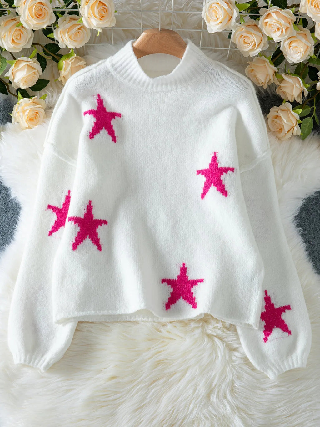 White women's loose fit turtleneck sweater with a black five-pointed star pattern on the front.