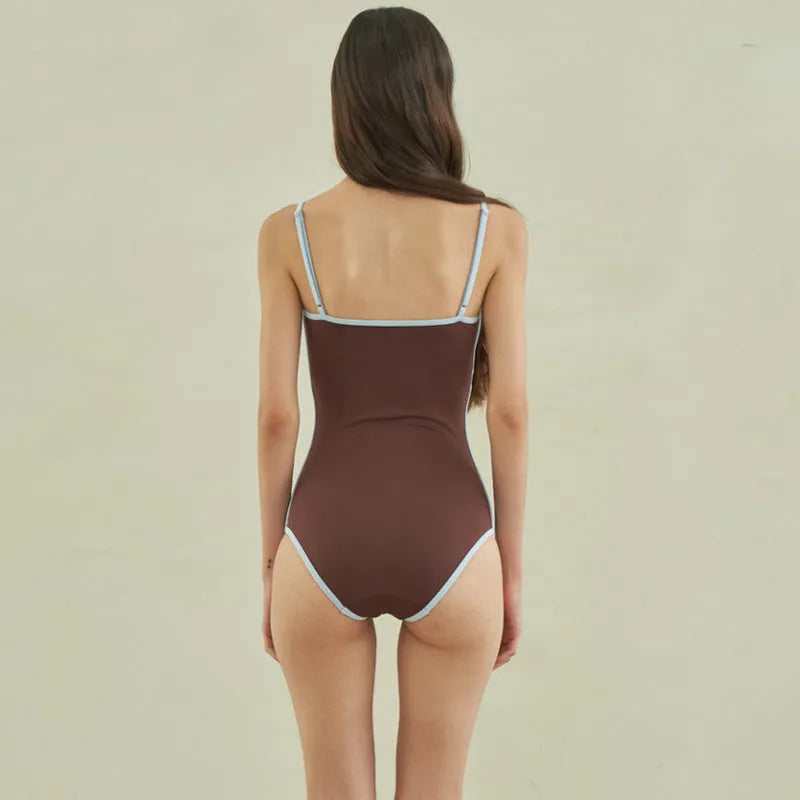 Brown women's one-piece swimsuit with a triangle top on a mannequin.