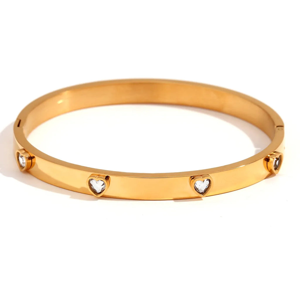 Gold stainless steel women's bracelet with a small micro-inlaid peach heart, shown with green and white diamond accent options.