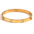 Gold stainless steel women's bracelet with a small micro-inlaid peach heart, shown with green and white diamond accent options.