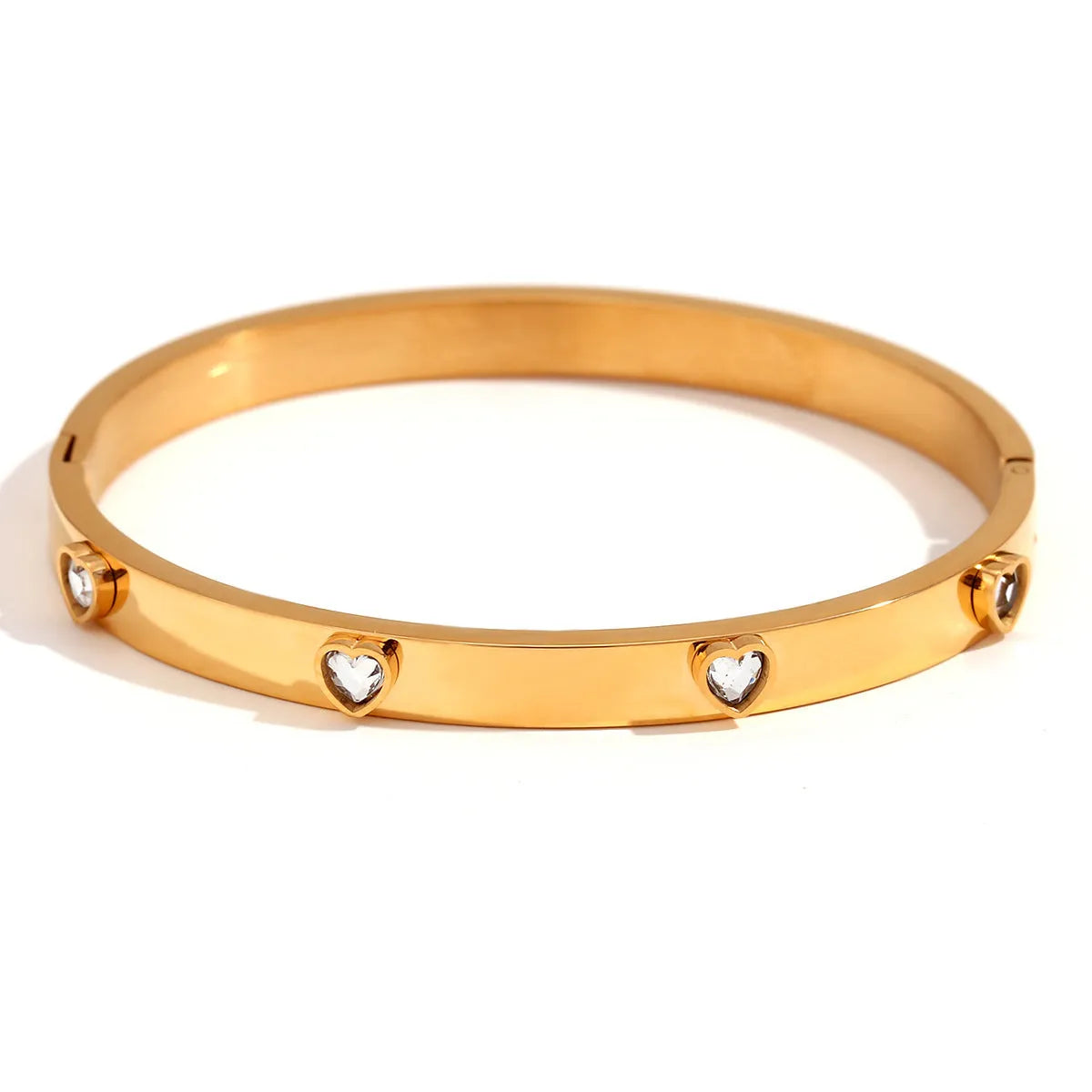 Gold stainless steel women's bracelet with a small micro-inlaid peach heart, shown with green and white diamond accent options.