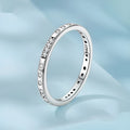 Moss Password I Love You silver ring with oxidised black finish on a model's finger, showing simple bracelet style.