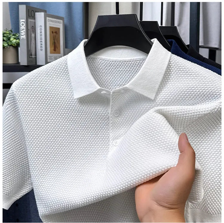 Loose-fitting short sleeve cotton pullover sweater in a neutral colour on a hanger.