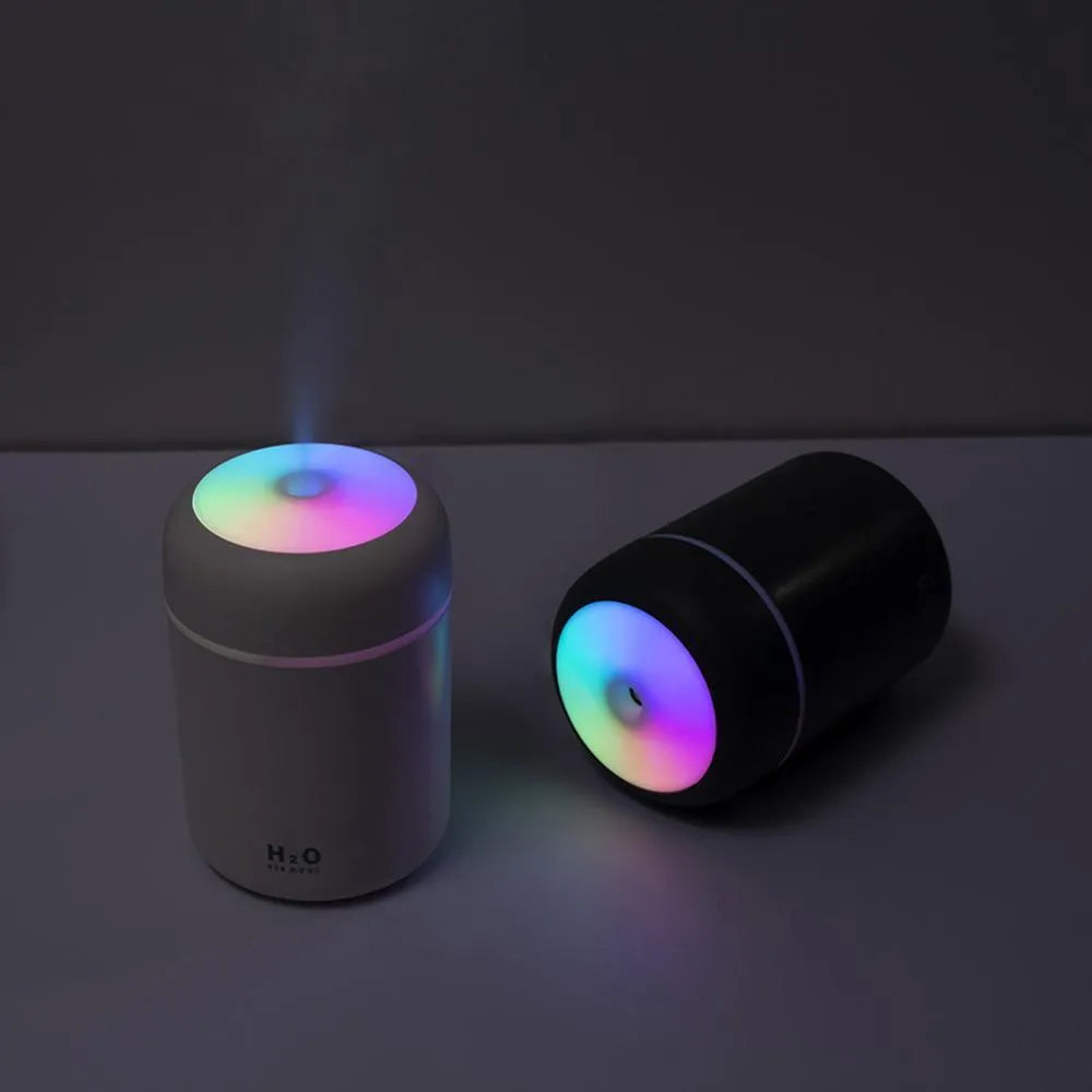 USB-powered mini humidifier with colourful LED lights in pink, white, or navy blue colour options