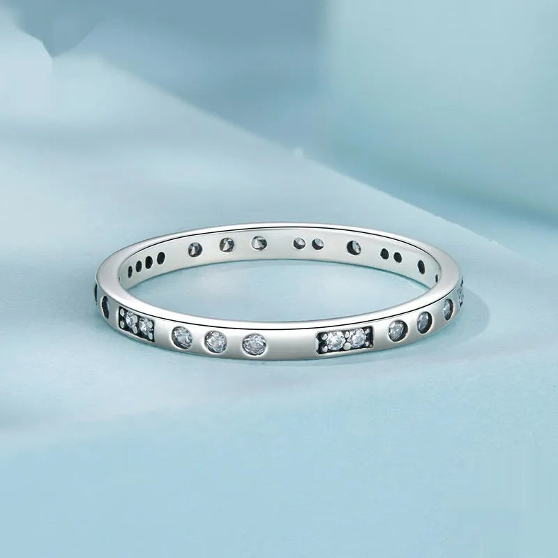 Moss Password I Love You silver ring with oxidised black finish on a model's finger, showing simple bracelet style.